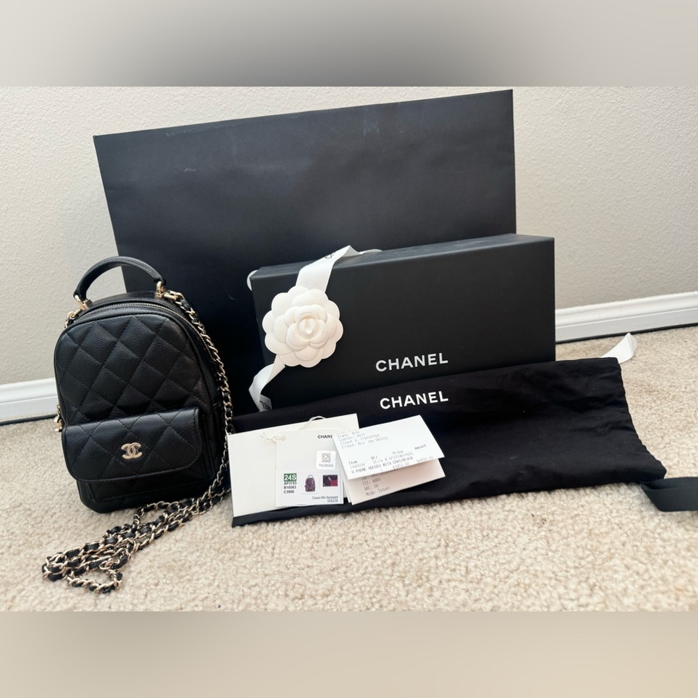 Chanel Black Mini Quilted Backpack with champagne Accents.